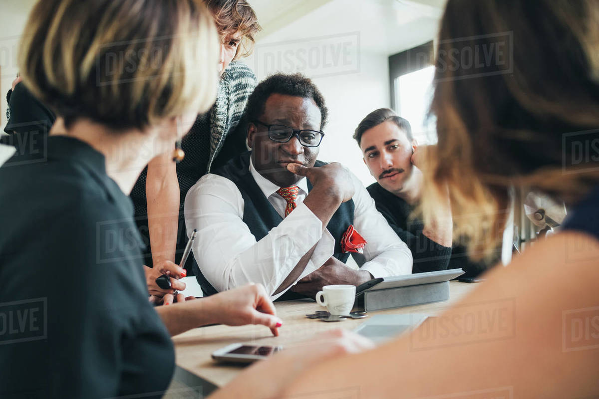 Businessmen and businesswomen having discussion in loft office Royalty-free stock photo