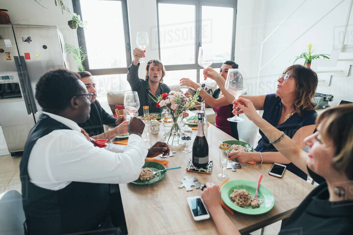 Businessmen and businesswomen celebrating at lunch party in loft office Royalty-free stock photo