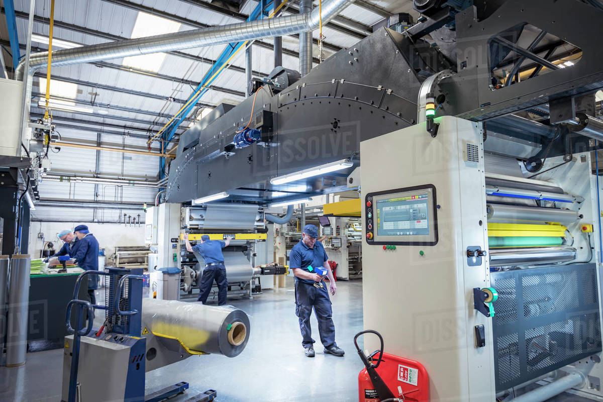 Wide angle view of food packaging machine and workers in print factory Royalty-free stock photo