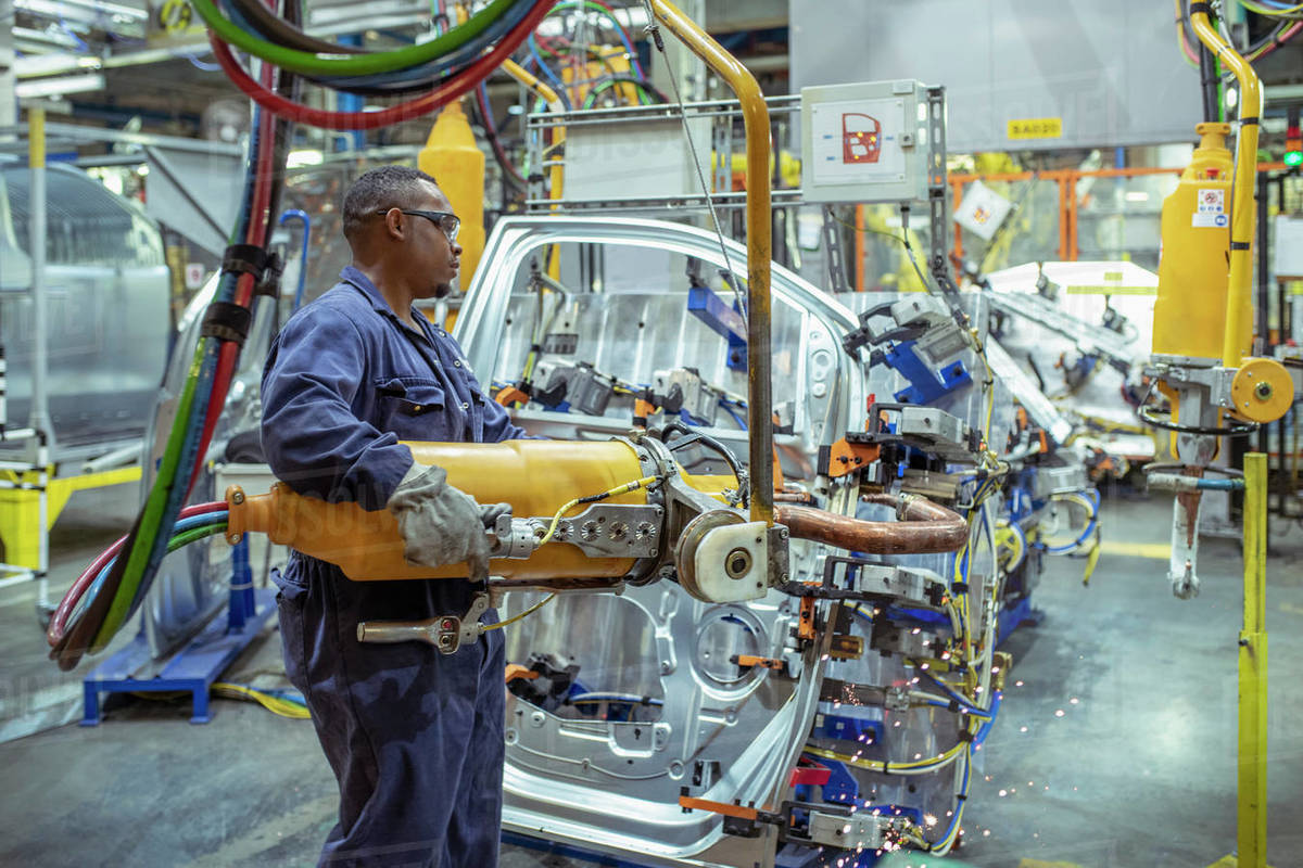 Worker spot welding car door in car factory Stock Photo Dissolve