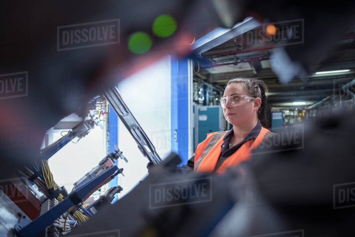 Female worker assembling vehicle roofs in car factory Royalty-free stock photo