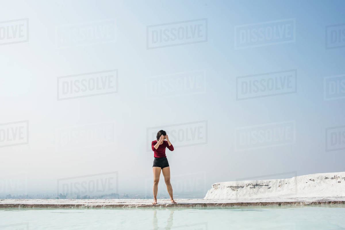 Woman looking down at thermal pool, Pamukkale, Denizli, Turkey Royalty-free stock photo