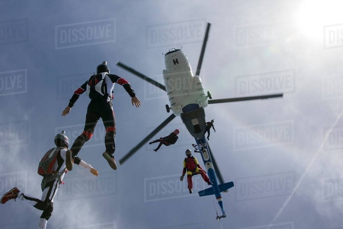 Low angle view of helicopter and six skydivers free falling, Siofok, Somogy, Hungary Royalty-free stock photo