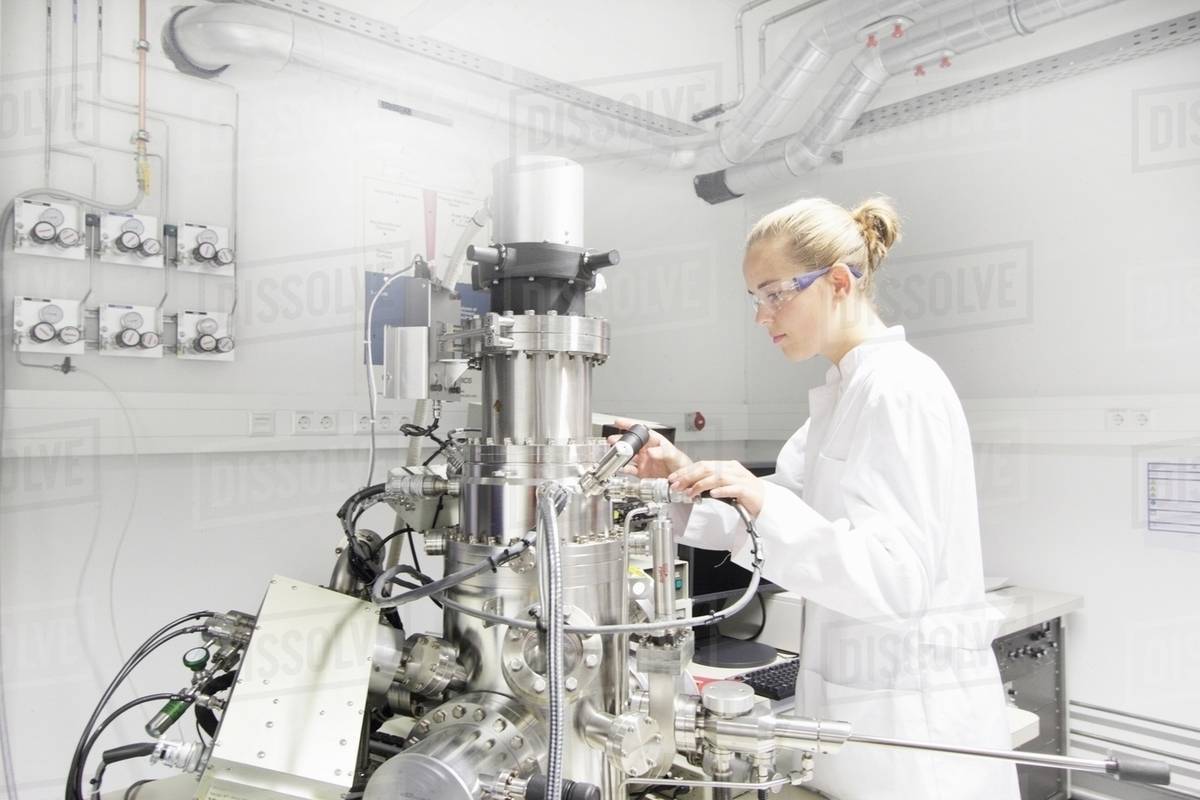 Technician working in optical laboratory Stock Photo Dissolve