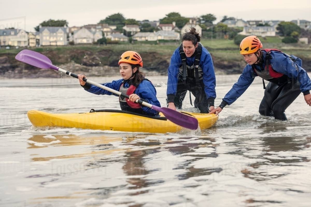 Woman learning how to sea kayak, Cornwall, England Stock Photo Dissolve