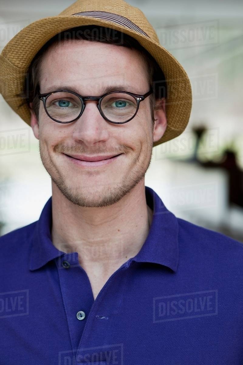 Man wearing glasses and straw hat Stock Photo Dissolve