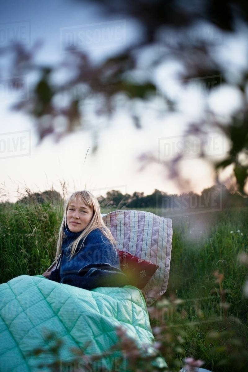 Woman wrapped in blankets outdoors Stock Photo Dissolve