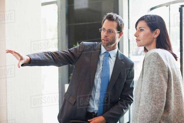Business man and woman talking - Royalty-free Stock Photo | Dissolve