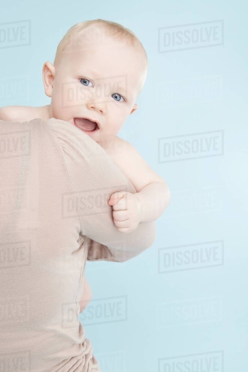 Mother carrying baby boy Stock Photo Dissolve