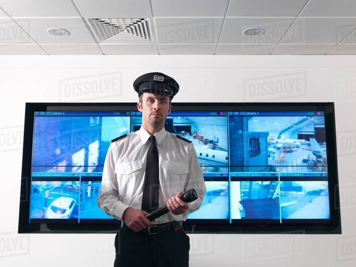 Security guard in control room Stock Photo Dissolve