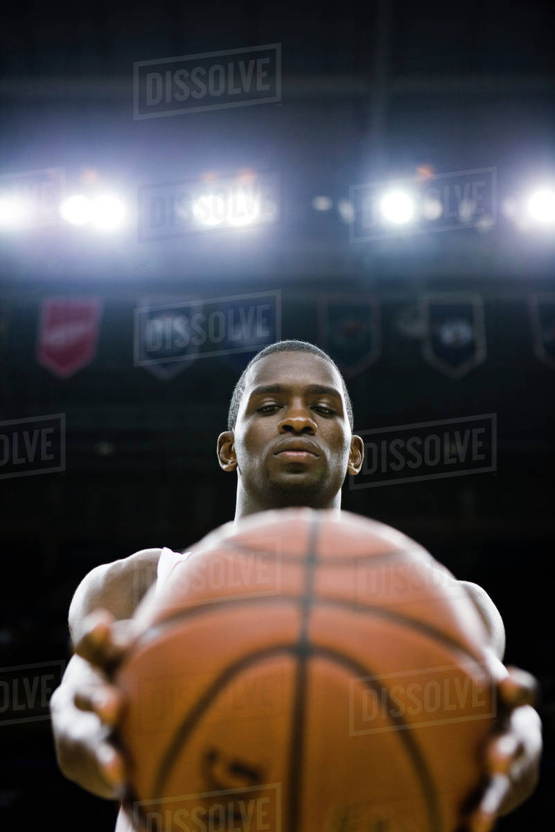 basketball player holding basketball stock photo dissolve
