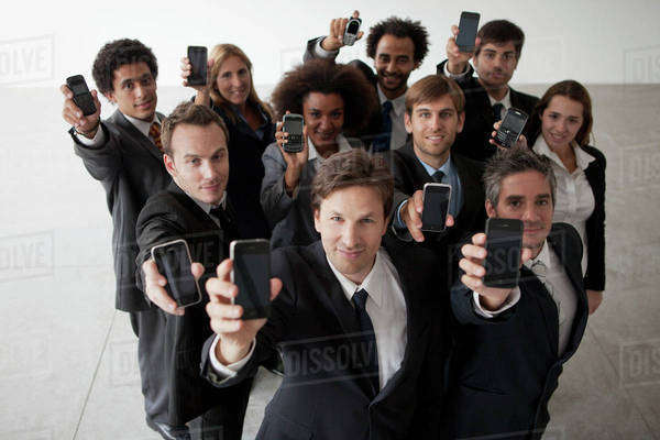 Business professionals holding aloft their cell phones - Royalty-free ...