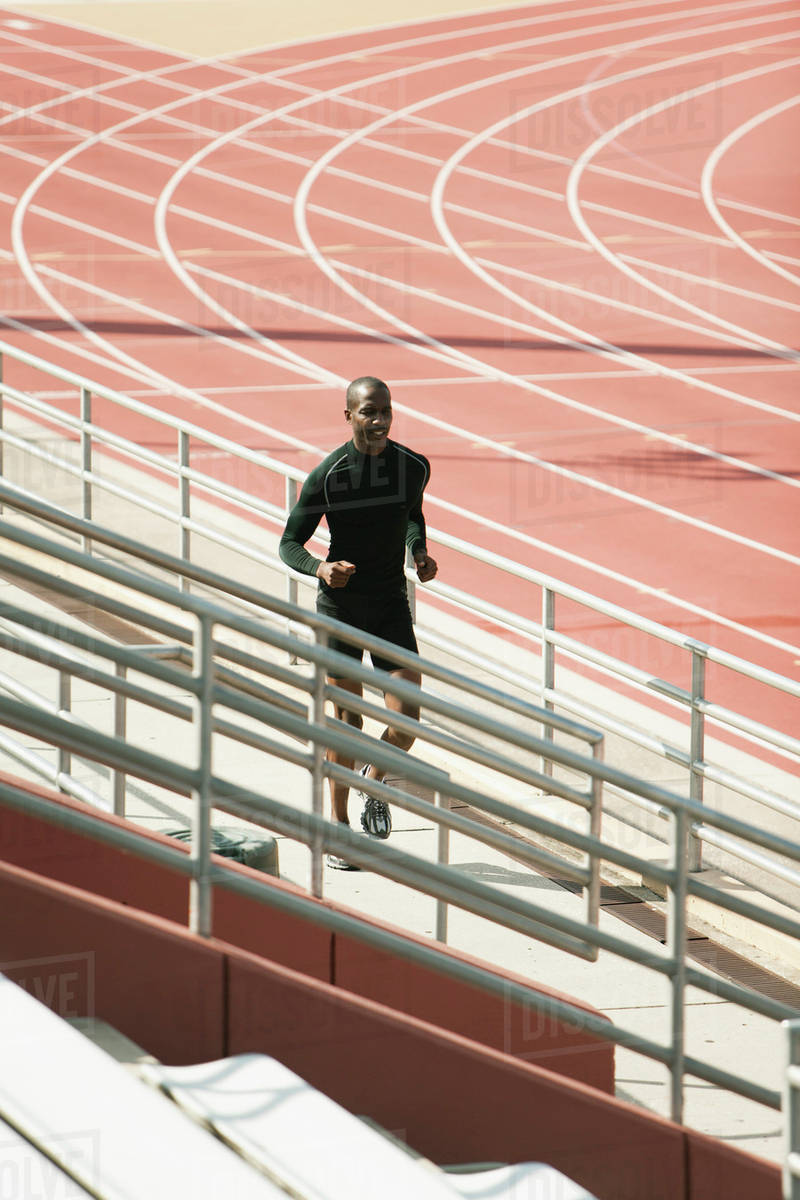 Man running bleachers Stock Photo Dissolve