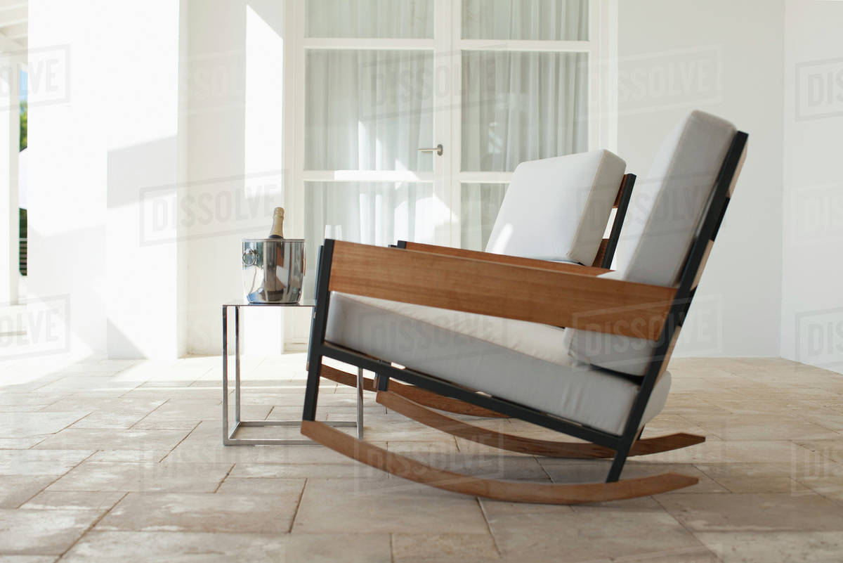 Rocking chairs and champagne bucket on patio Royalty-free Stock