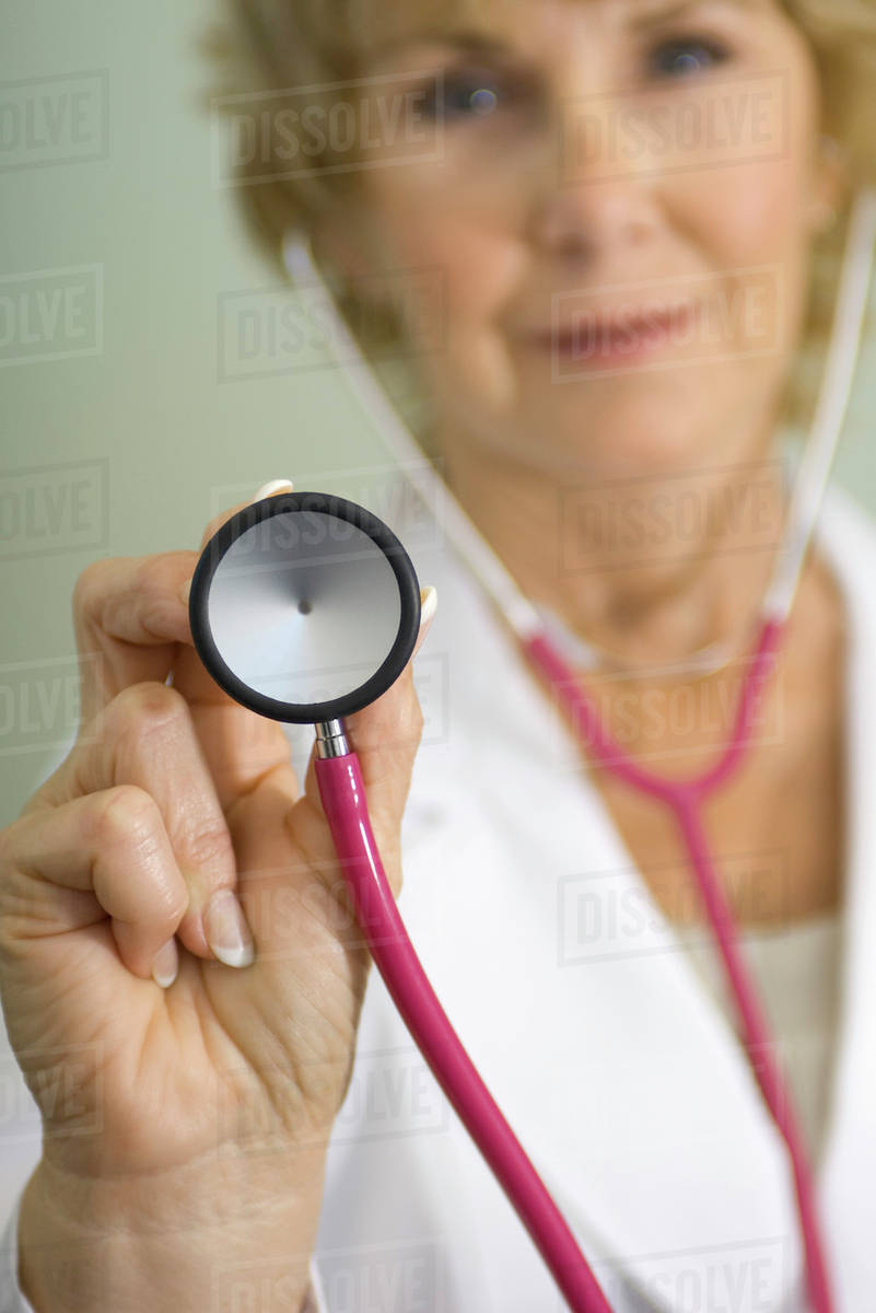 Doctor with stethoscope preparing to give medical exam Stock Photo