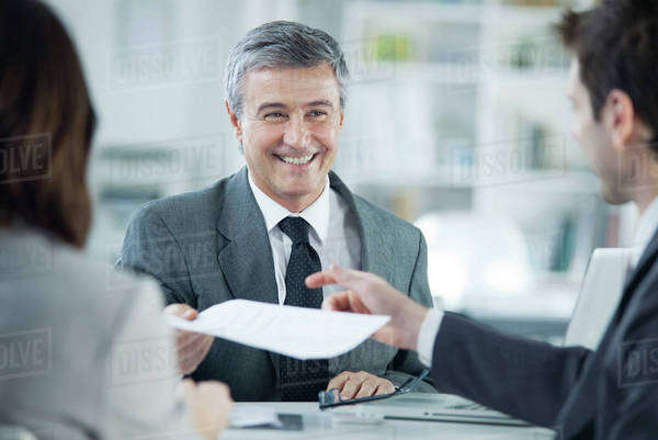 Businessman smiling during meeting with clients - Royalty-free Stock ...