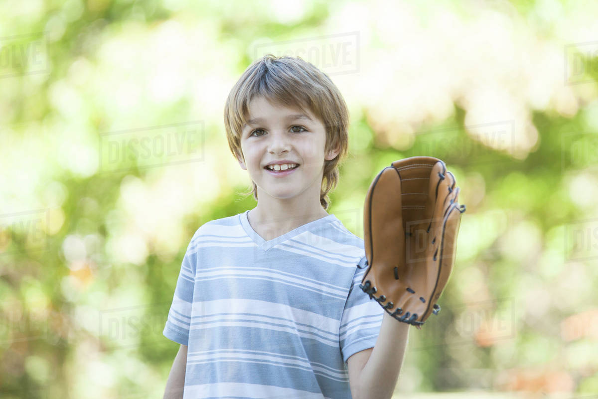 Boy wearing baseball glove Stock Photo Dissolve