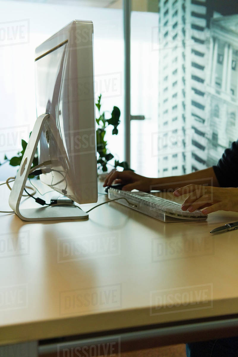 Person using desktop computer in home office - Royalty-free Stock Photo ...
