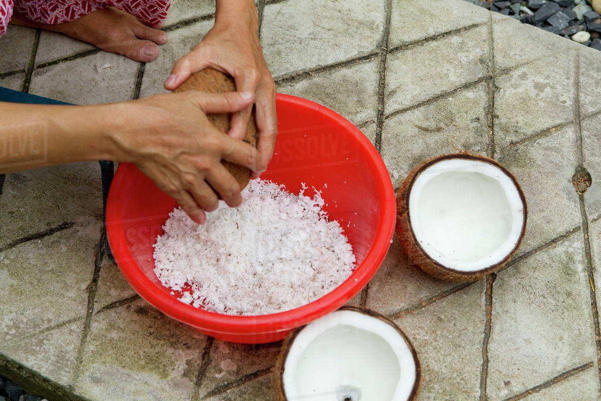 Grating fresh coconut Stock Photo Dissolve