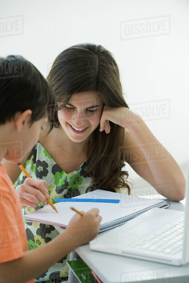 Tutor helping elementary school student Stock Photo Dissolve