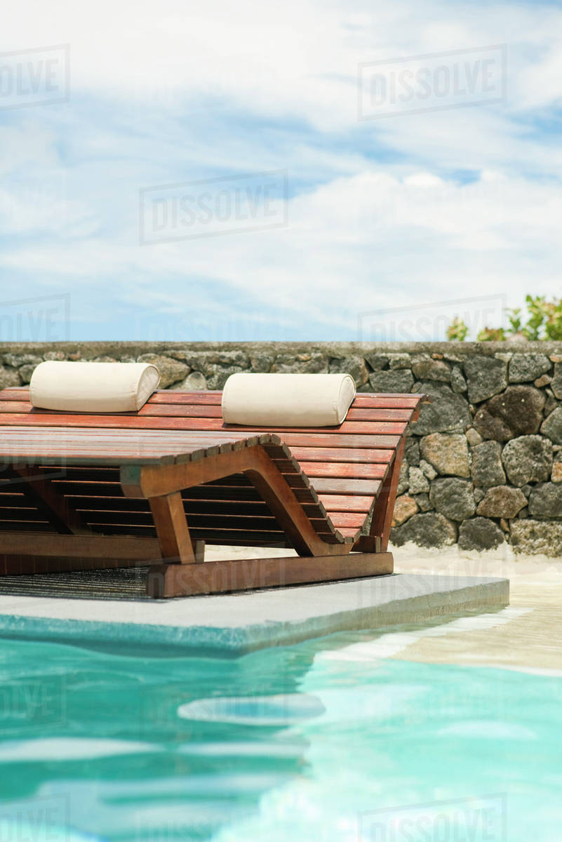 Wooden Lounge Chairs In Pool Stock Photo Dissolve Wooden Lounge Chairs In Pool Stock