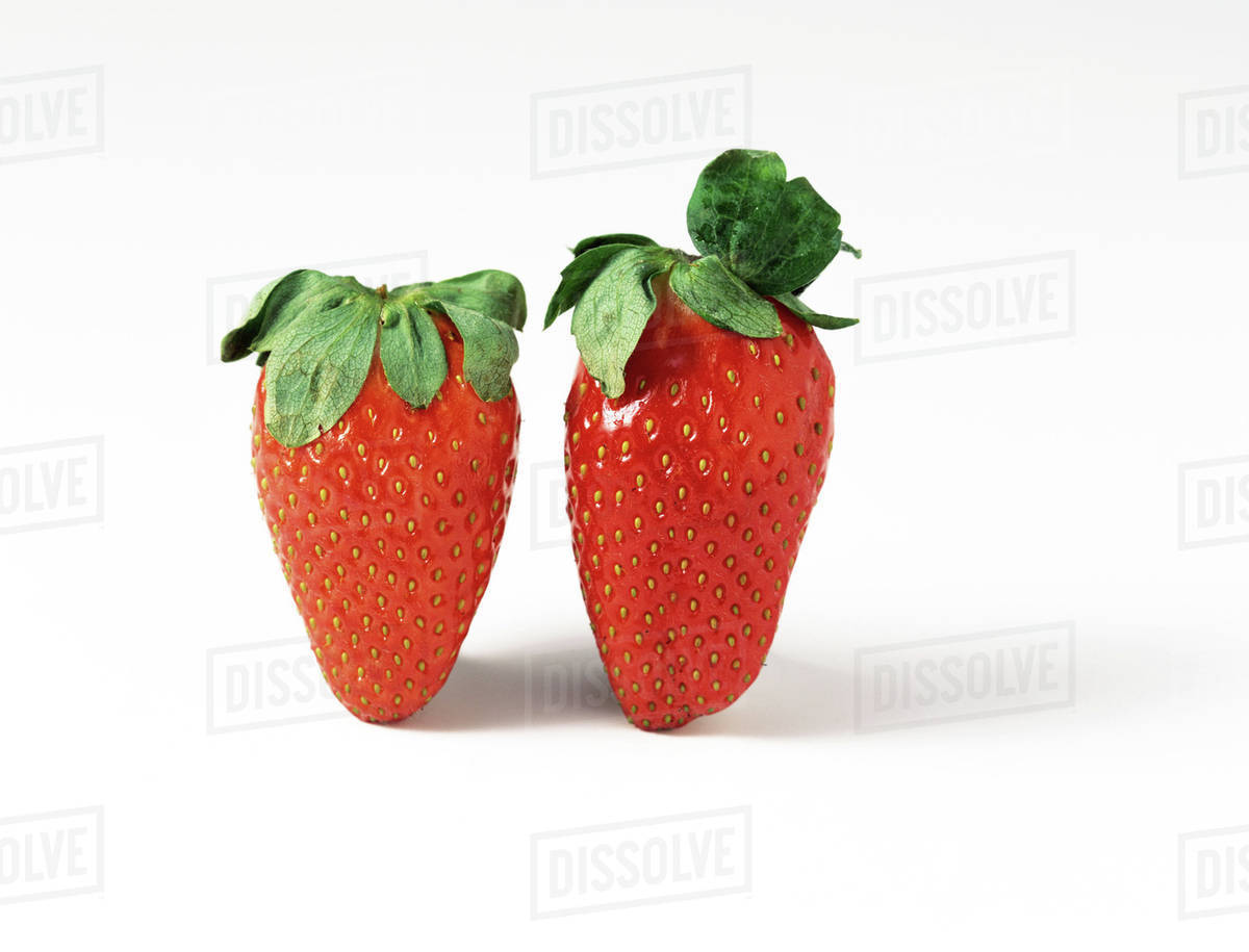 Two strawberries, closeup Stock Photo Dissolve