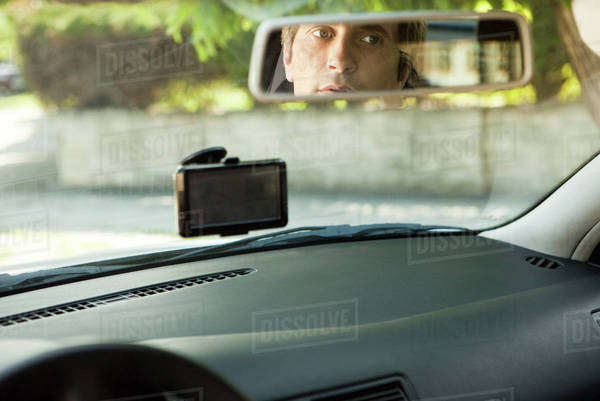 Driver checking rear-view mirror - Royalty-free Stock Photo | Dissolve