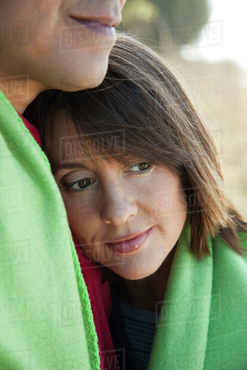 Woman resting head on husband’s chest, portrait - Stock Photo - Dissolve