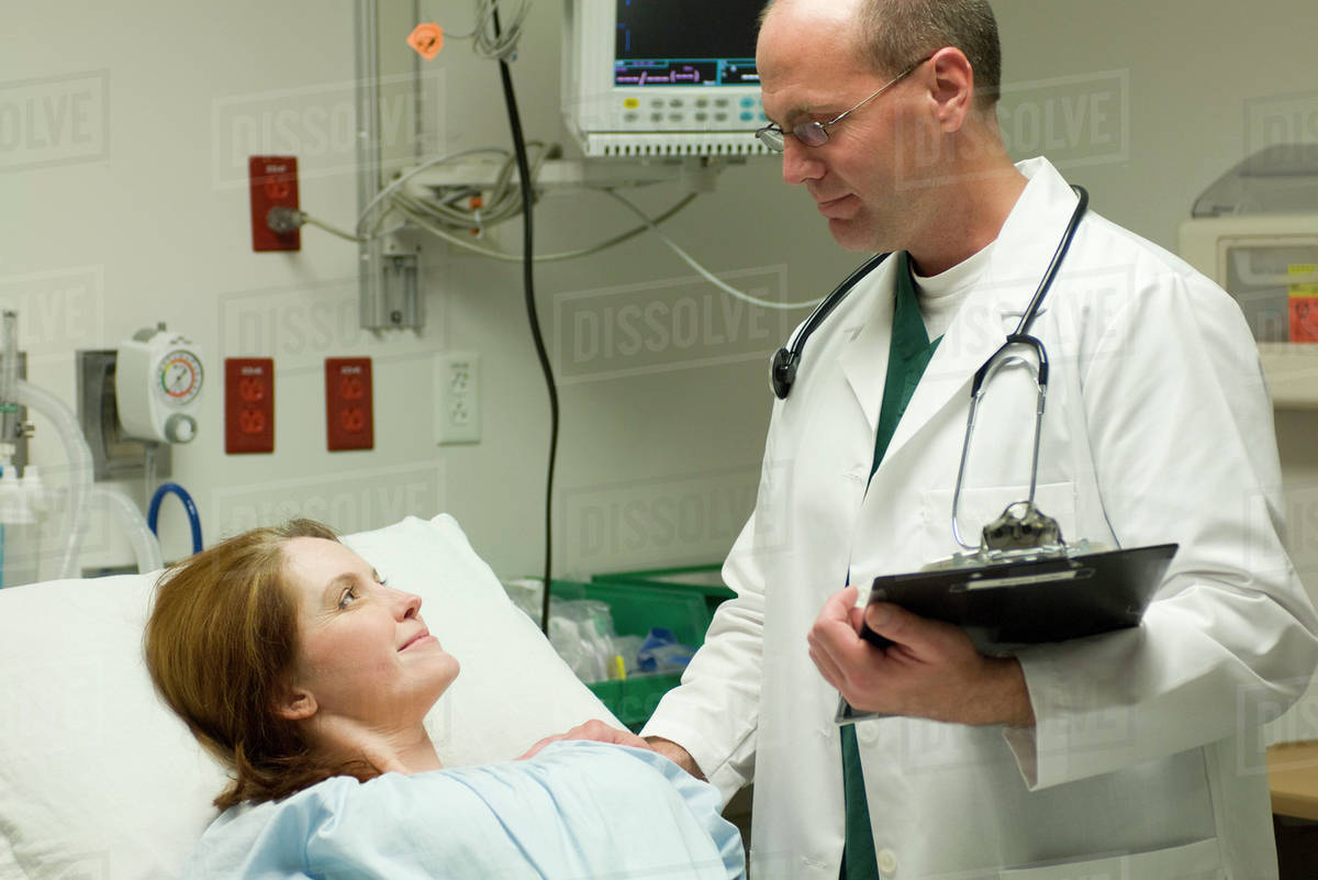 Doctor reassuring patient in hospital Stock Photo Dissolve