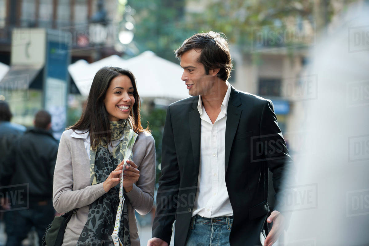 Couple walking and talking together outdoors Stock Photo Dissolve