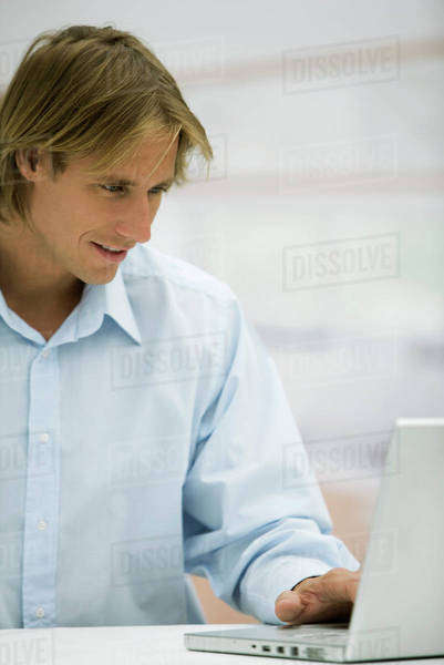 Man using laptop computer - Royalty-free Stock Photo | Dissolve