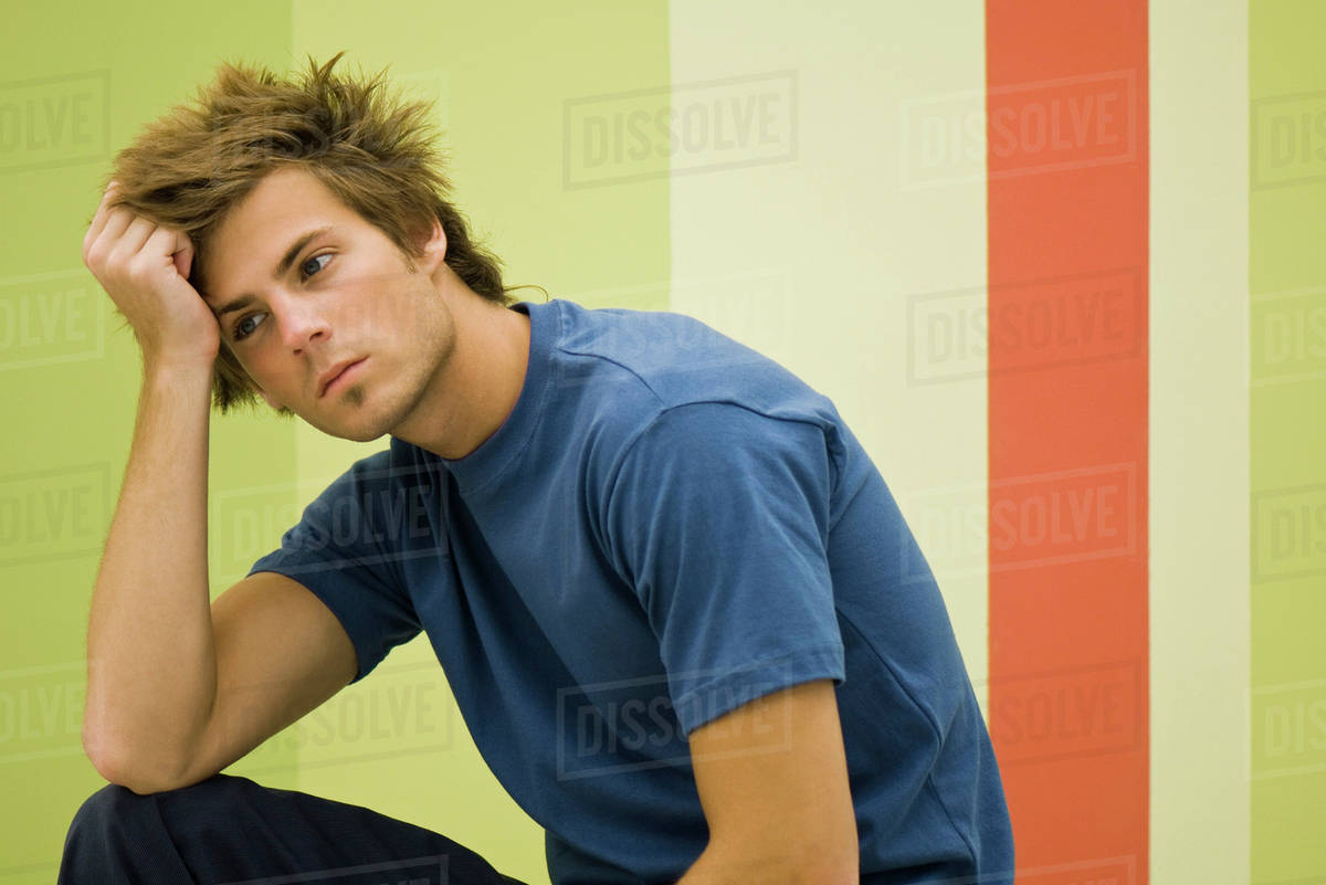Young man deep in thought Stock Photo Dissolve