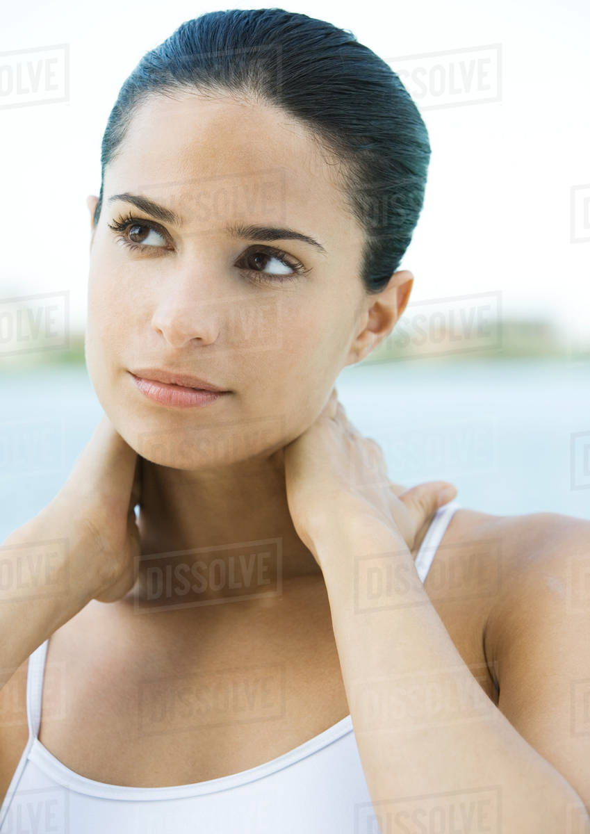 Woman with hands behind neck Stock Photo Dissolve