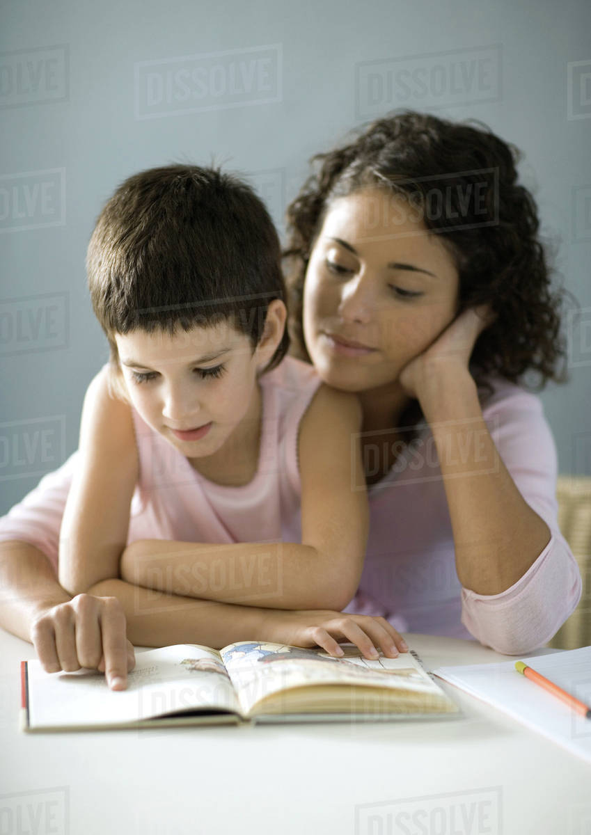 Mother and child reading book - Stock Photo - Dissolve