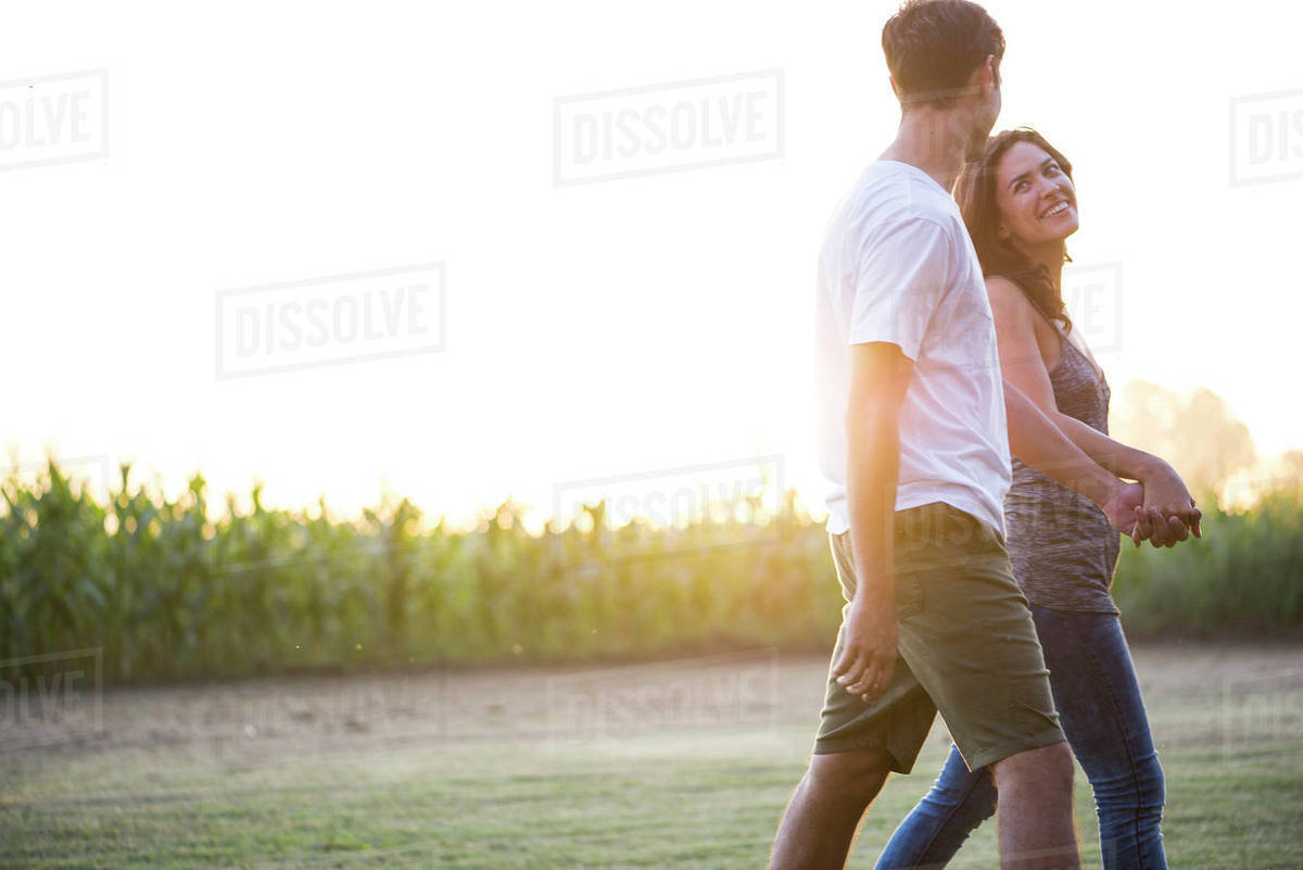 Couple taking walk together outdoors Stock Photo Dissolve