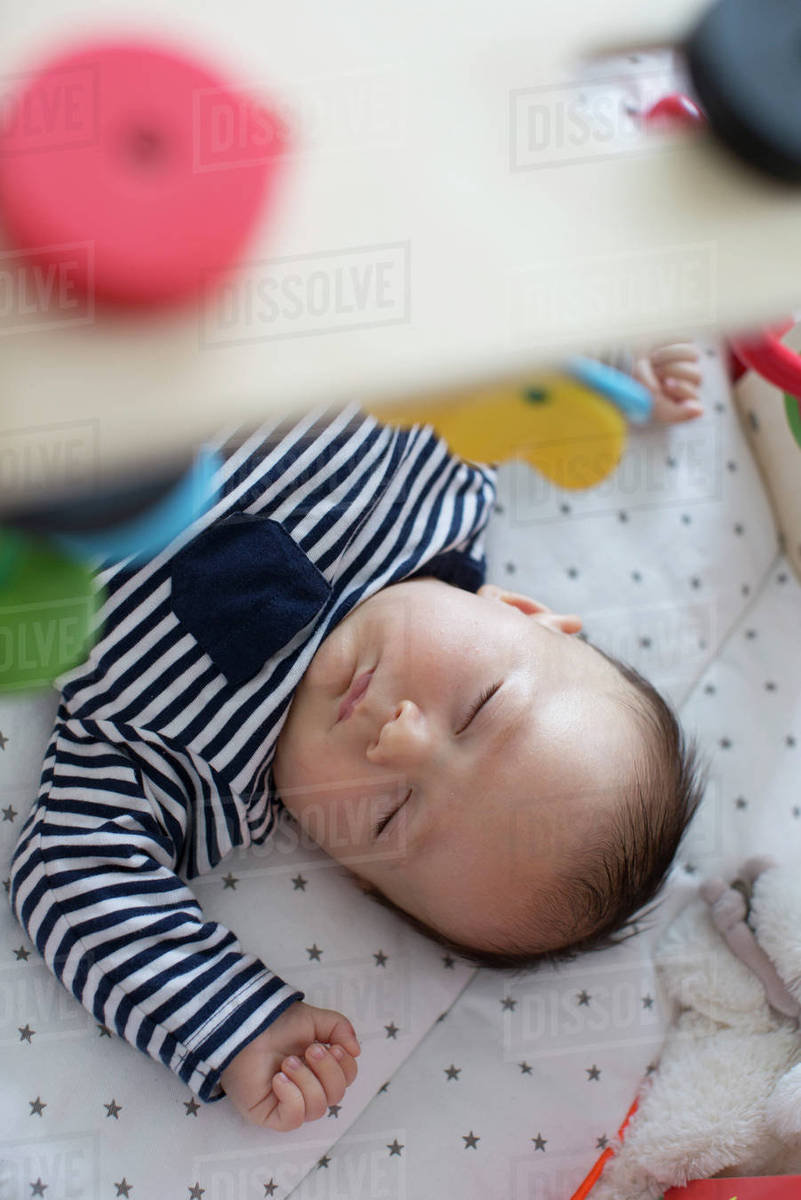 Baby sleeping in crib Stock Photo Dissolve