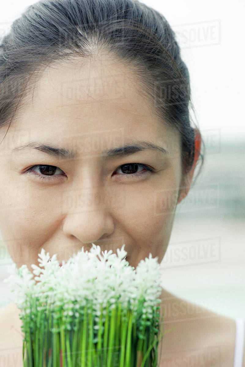 Woman smelling flowers Stock Photo Dissolve