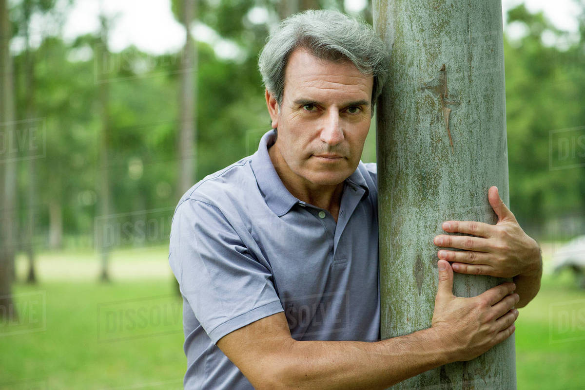 Man hugging tree - Stock Photo - Dissolve