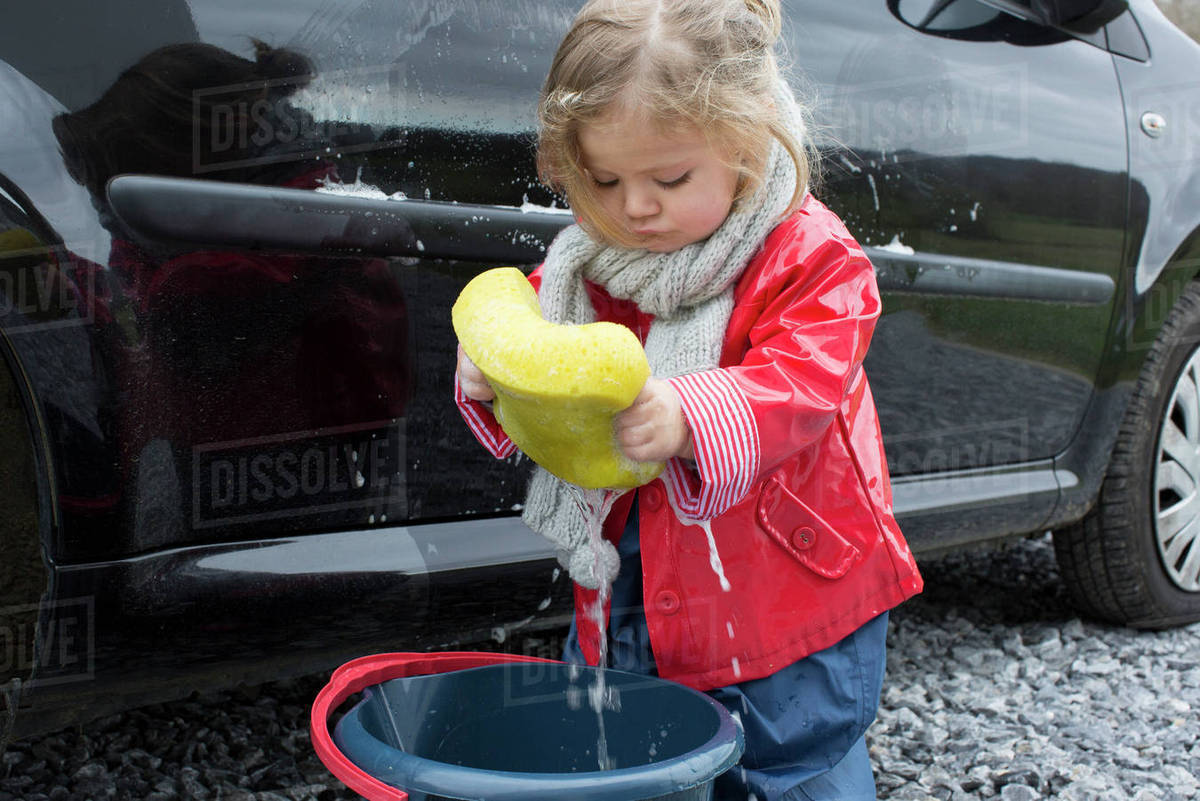 Little girl washing car Stock Photo Dissolve