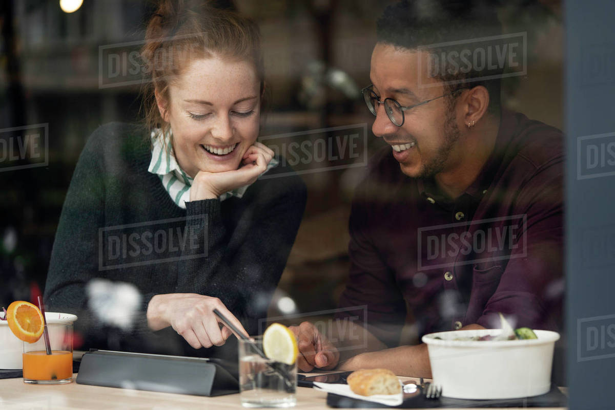 Couple sitting in restaurant Stock Photo Dissolve