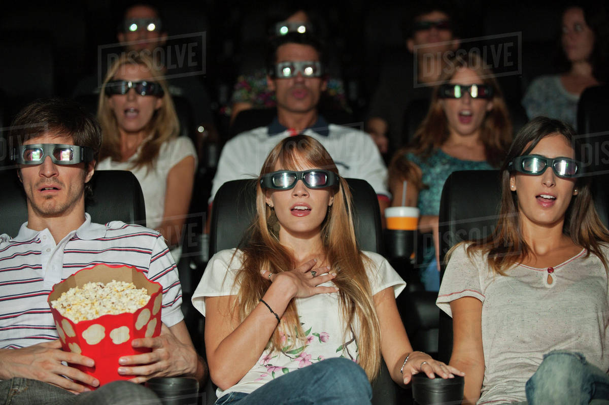 Audience wearing 3D glasses in movie theater Stock Photo Dissolve