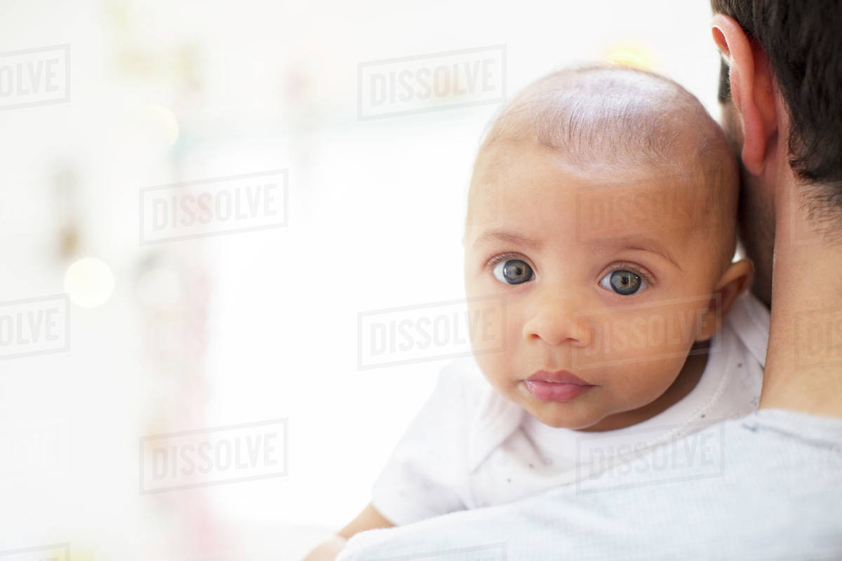 Father carrying baby boy Stock Photo Dissolve