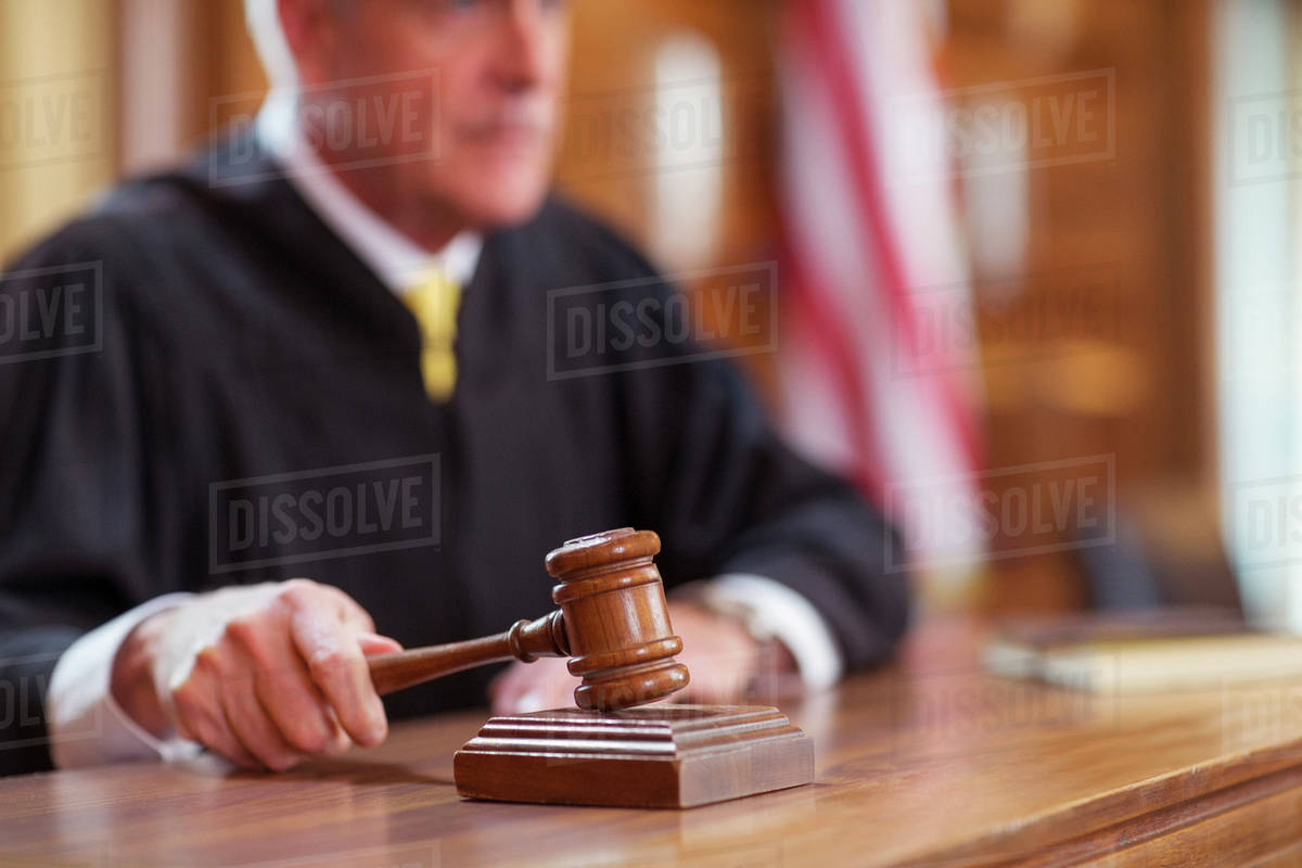 Judge banging gavel in court Stock Photo Dissolve
