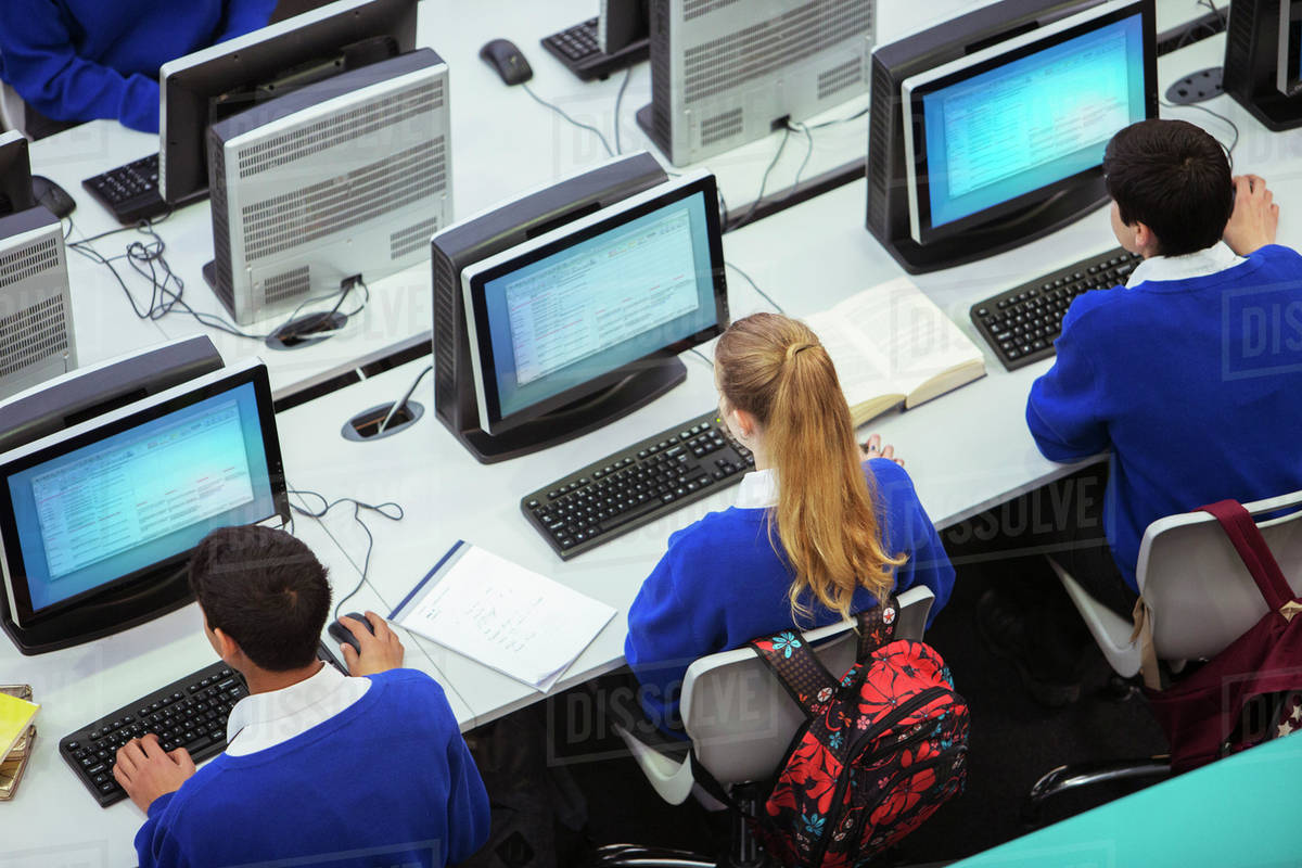 Elevated view of students sitting and learning in computer room ...