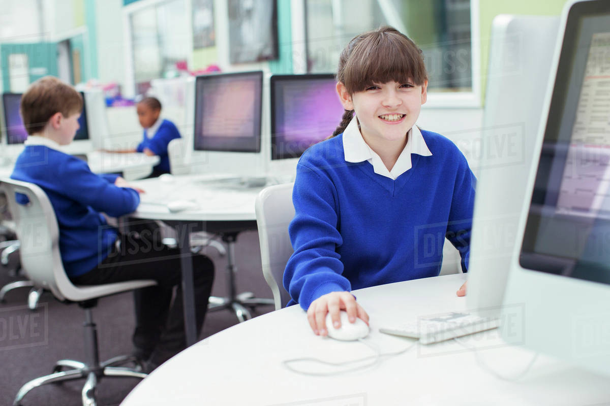 Portrait of primary school girl wearing blue school uniform using ...