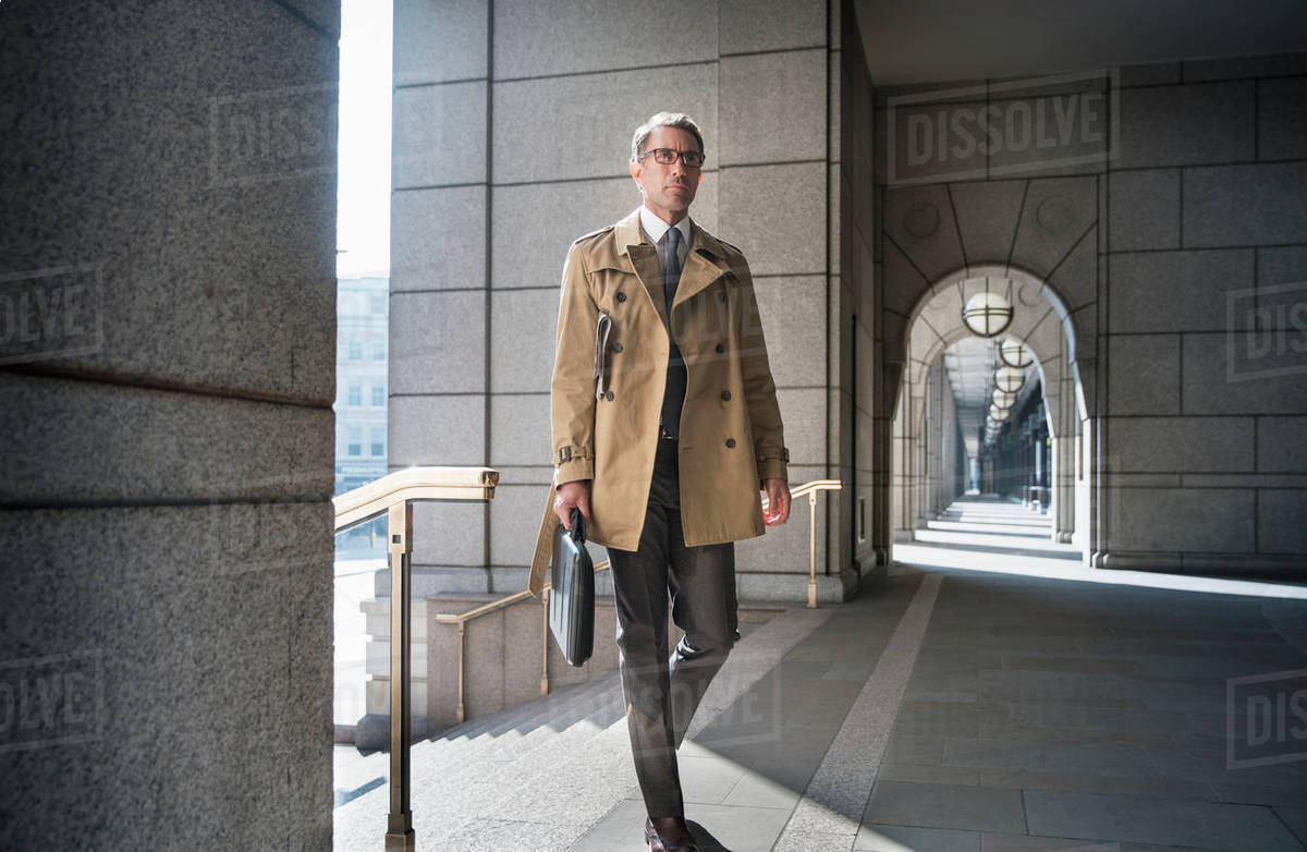 Corporate businessman in trench coat 