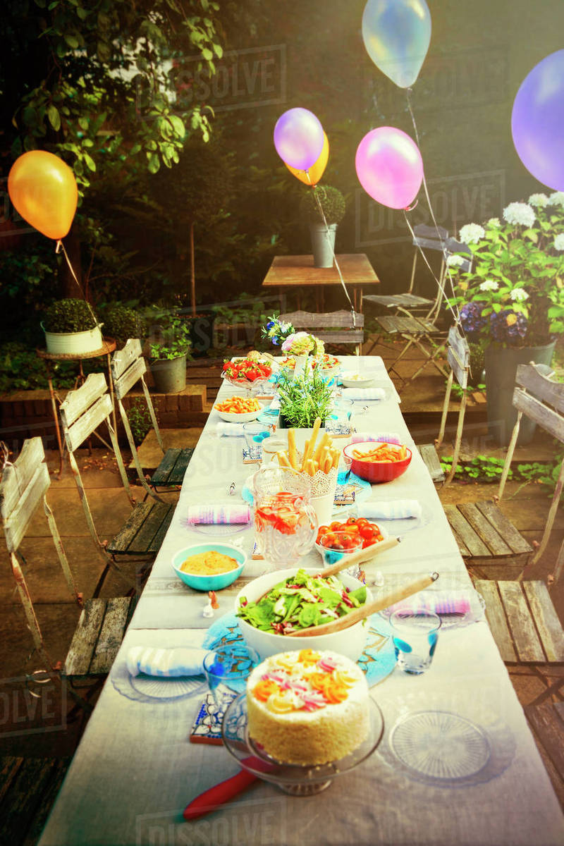 Balloons and food at garden party patio table Royalty-free stock photo