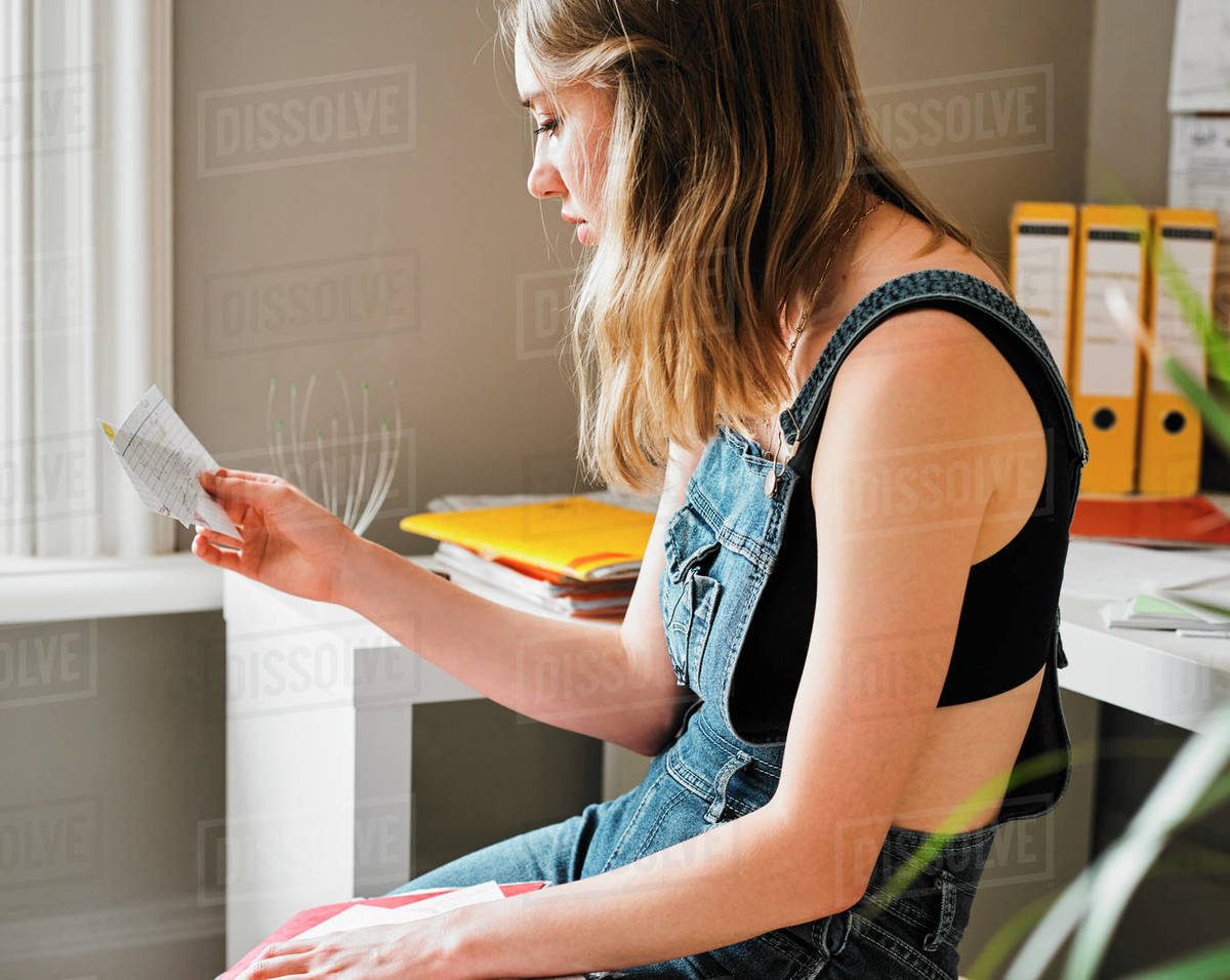 Young female college student studying with flash cards Stock Photo