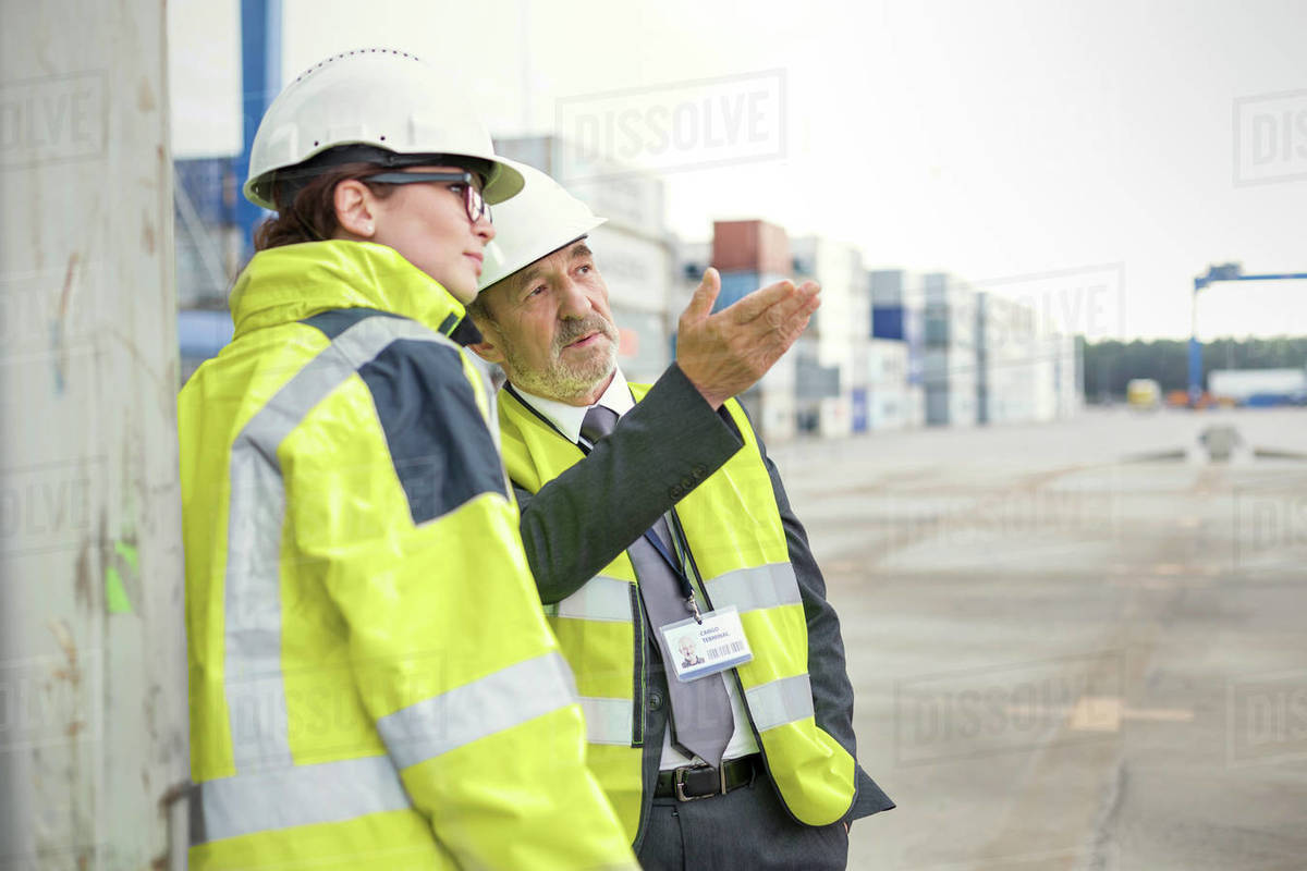 Dock manager and worker talking at shipyard Stock Photo Dissolve
