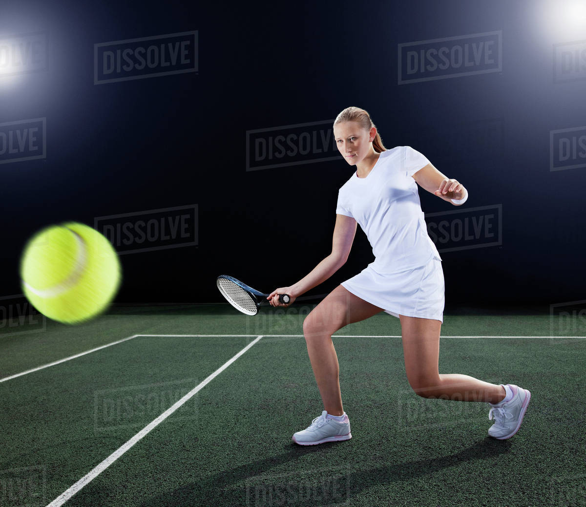 Tennis player hitting ball on court Stock Photo Dissolve